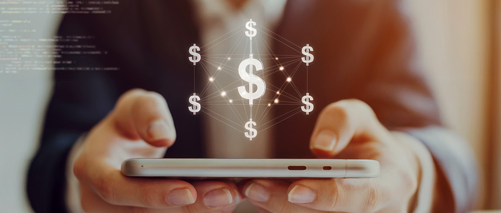 Holding phone with money symbols flying out